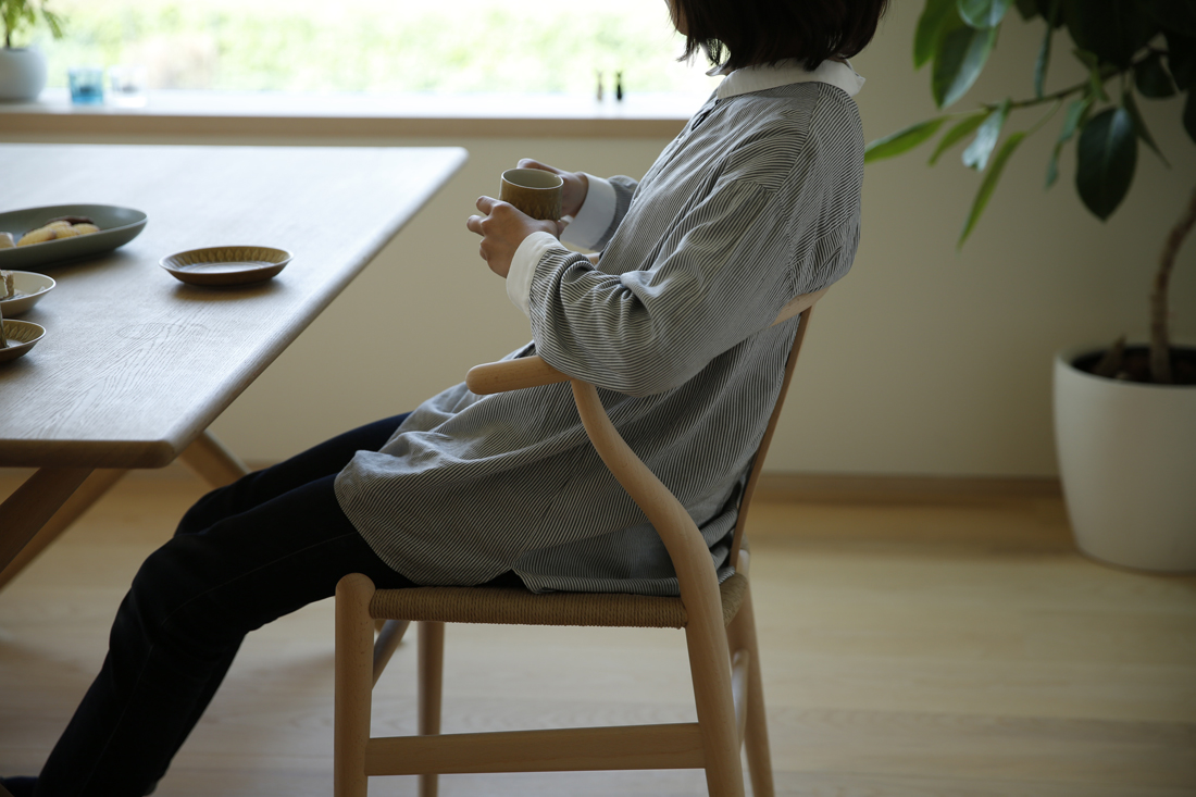 Yチェアに座って一息つく様子